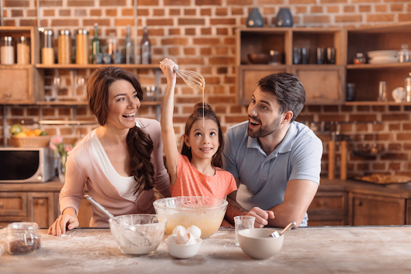 parents and daughter baking