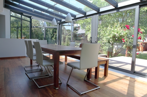 Modern conservatory with a table and chairs