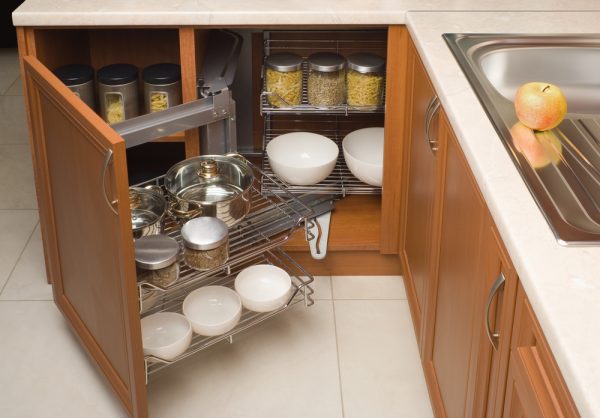 detail of open kitchen cabinet with specialised storage solutions within it