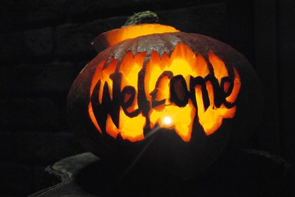 A pumpkin with welcome carved into it