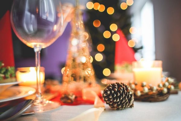 A blurred image of a table and tree decorated for Christmas