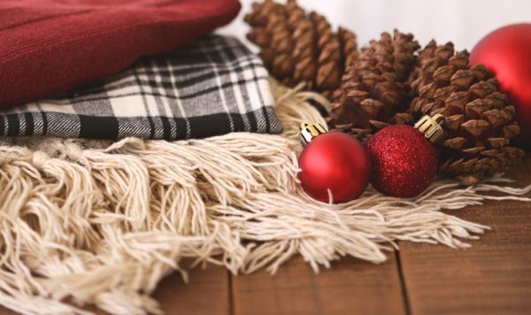 Pine cones, baubles and a blanket on a rug