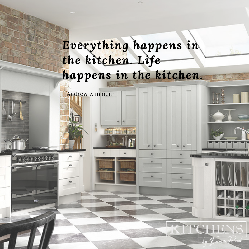 A square kitchen with a brick wall and titled floor