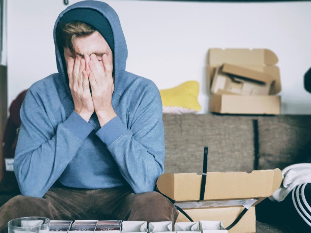 a man with his head in his hands to symbolise design mistakes made during a renovation